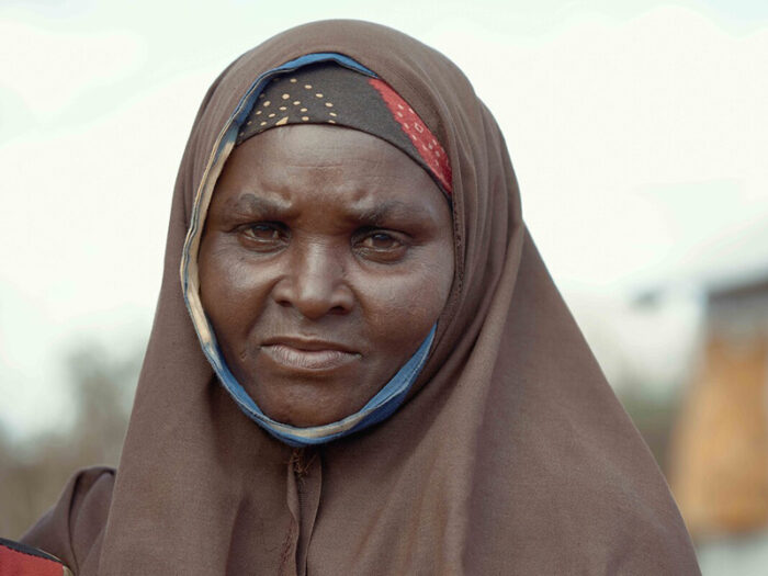 Portrait of a lady wearing a light brown head scarf