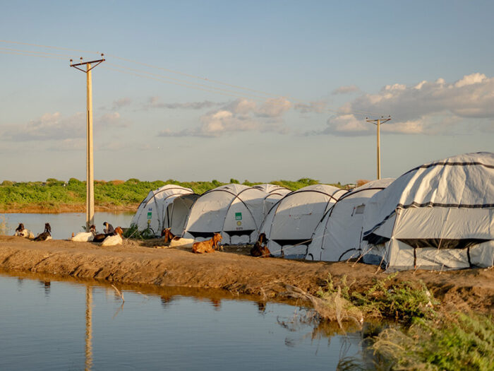 White tents next to flood water in Pakistan